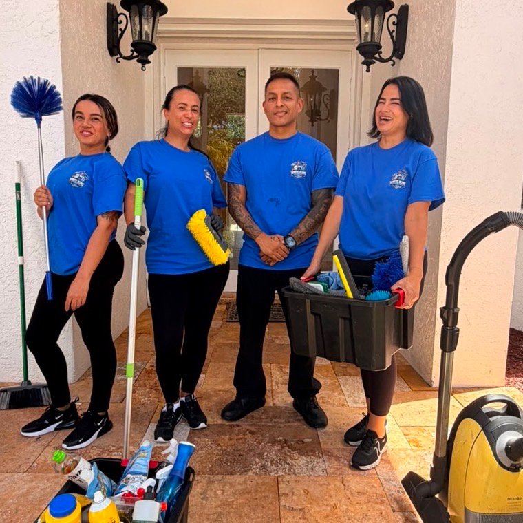 Four White Glove team members with vacuum, dusters and supply bins